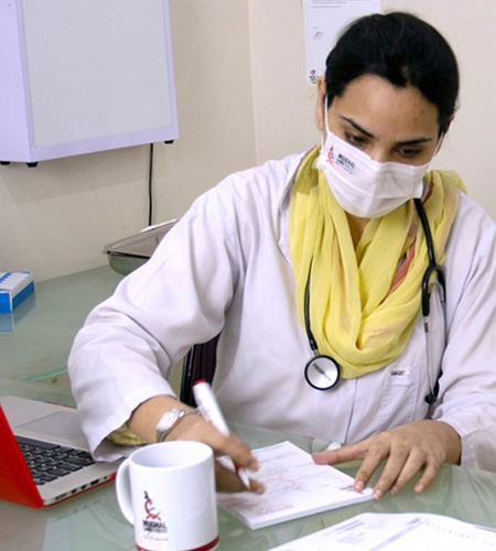 Female doctor writing a prescript at Mughal Clinic